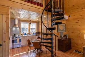 a kitchen with a spiral staircase in a log cabin at Retreat at Riverbend in West Jefferson +16 photos