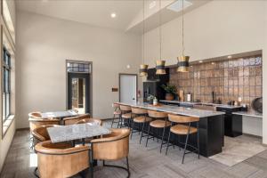 a kitchen with a bar with chairs and tables at Evergreen Retreat Red Lodge in Red Lodge