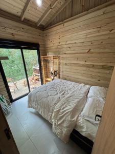 En eller flere senge i et værelse på Casa Rosa Sul