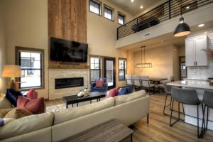 a living room with a couch and a table at Yellowstone Yonder Red Lodge in Red Lodge