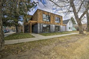 a house with a wooden facade with a tree at Hauser House Unit 1 in Red Lodge