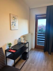 a room with a desk and a door with a window at Waldhotel Süllhof in Steyerberg +27 photos