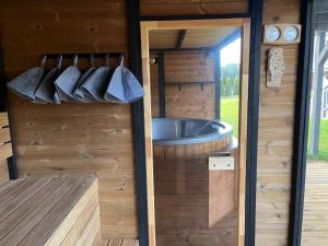 a sauna with a tub in a wooden cabin at Wypoczynek KOPANICA in Kopanica +49 photos