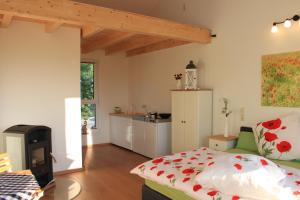a bedroom with a bed and a kitchen at Fährhaus Gruna in Gruna