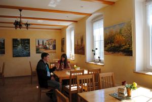 a man and woman sitting at a table in a restaurant at Fährhaus Gruna in Gruna
