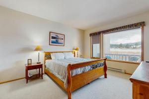 a bedroom with a bed and a large window at Park 282 in Big Sky
