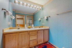 a bathroom with two sinks and a mirror at Park 282 in Big Sky +23 photos