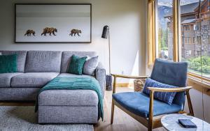 a living room with a couch and a chair at Tranquility at Rundle Cliffs Lodge in Canmore +74 photos