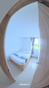 a bedroom with a bed in a room with a mirror at Amanecer Caribe 4503 in Coveñas
