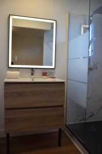 a bathroom with a sink with a mirror and a shower at Ti An Eizh - Charming Townhouse - Near Vannes in Treffléan +40 photos