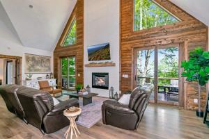 a living room with leather chairs and a fireplace at Beech Blessings in Beech Mountain
