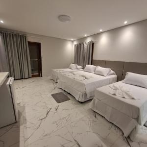 Ένα ή περισσότερα κρεβάτια σε δωμάτιο στο Reale Paraty