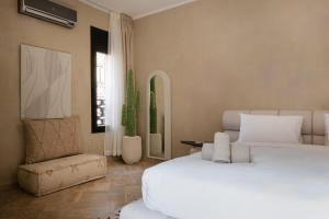 Un dormitorio con dos camas blancas y una silla. en Villa Riad Private heated Pool with breakfast, en Marrakech 40 fotos más