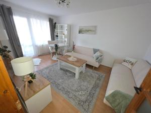 a living room with a couch and a table at Apartament Abby in Sighişoara +1 photo