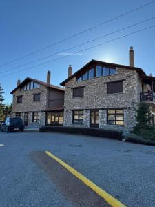 a stone building with a car parked in front of it at Frigias 4 in Arachova