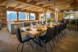 Chalet Serbijanka Alpine Retreat with Hammam Sauna and Jacuzzi for 14 Gueststs في مانيجود: غرفة طعام كبيرة مع طاولة طويلة وكراسي