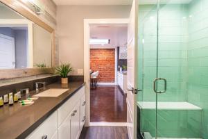 a bathroom with a glass shower and a sink at Family-Friendly Apartment with Kitchen in San Diego +19 photos