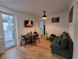 a living room with a couch and a table at Residence Pod Bublavou in Kraslice