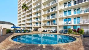 a swimming pool in front of a hotel at Beachcrest 805 in Santa Rosa Beach