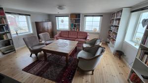 a living room with a couch and a table and chairs at Kringelgården in Stamsmåla
