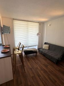 a living room with a couch and a table at Beautiful Portal Santo Domingo Apartment in San Antonio