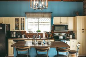 a kitchen with a table with chairs and a refrigerator at Jones Beach Houseboat in Seaford