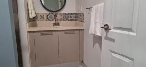 a bathroom with a sink and a mirror at Casa Bellavista - 2BR Beachview Villa by Veritas Pacifica in San Diego +3 photos
