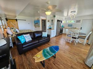 a living room with a couch and a table at SeaSide Lake-Front Cottage in Madison