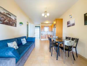 a living room with a blue couch and a table at Antonio 50 - Blue Glyfada Private Homes in Glyfada