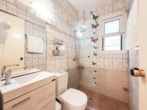 a bathroom with a toilet and a sink and a shower at Antonio 50 - Blue Glyfada Private Homes in Glyfada