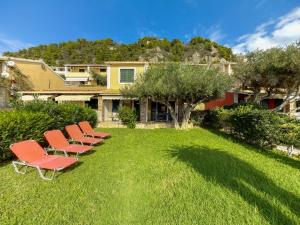 a row of chairs sitting on a lawn at Antonio 50 - Blue Glyfada Private Homes in Glyfada