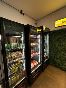 two refrigerators in a store with food and drinks at Haven Residence in Uberlândia
