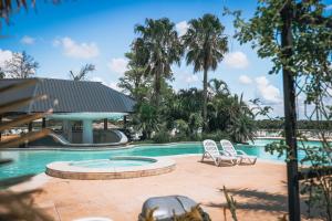 a swimming pool with two chairs and a slide at La Regina Lodge in Itatí