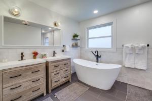 a bathroom with a tub and two sinks and a mirror at Upscale Family Retreat Near DC and Georgetown! in North Bethesda +34 photos