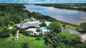 an aerial view of a resort next to a river at La Regina Lodge in Itatí