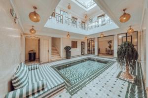 an indoor swimming pool in a house with a ceiling at Riad Valentine in Marrakech