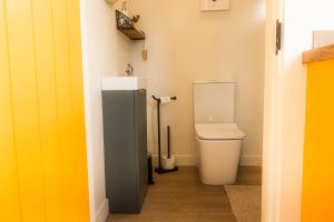 a bathroom with a toilet and a sink at Oaklane Glamping Cabins in Kenmare