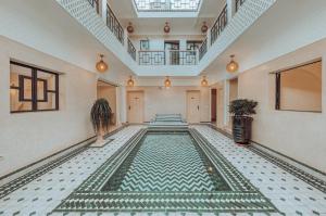 a pool in a room with a tile floor at Riad Valentine in Marrakech +88 photos