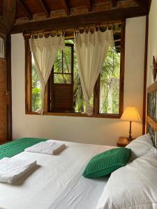 a bedroom with a large white bed with a window at Guest House Tânia Alves in Pratinha +286 photos