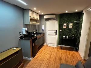 a kitchen with a sink and a counter top at Verdito House in Rio de Janeiro +33 photos