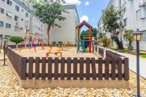 a playground with play equipment in front of a building at Apto a 650 m do MASC em Floripa BAS0401 in Florianópolis