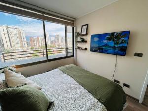 Un televizor și/sau centru de divertisment la 2D 2B, hasta 4 personas, Vista cordillera, Parking, AC & Calefacción