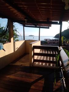 a balcony of a house with a view of the ocean at Recanto Jane e Daniel in Angra dos Reis