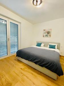 卢森堡High-End 3BR w terrace, garden&parking的一间卧室，里面有一张床和一扇大窗户。