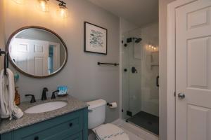 a bathroom with a sink and a shower at Retreat 7B - Jubilee in Edisto Island +22 photos