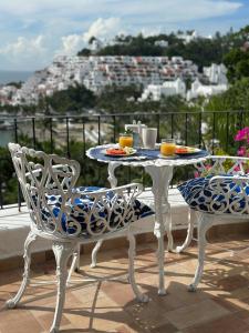 a table and chairs sitting on a balcony with a view at Santorini, loft frente al mar in Manzanillo
