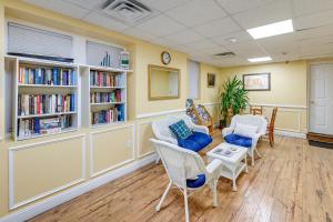 a waiting room with chairs and books at Explore Boardwalk and Beaches! Ocean City Condo in Ocean City