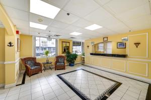 a lobby with a waiting room with chairs and a table at Explore Boardwalk and Beaches! Ocean City Condo in Ocean City
