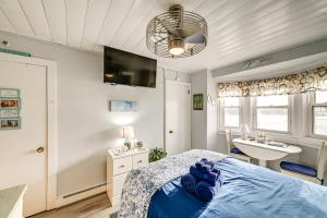 a bedroom with a blue bed and a sink at Walk to Beach and Music Pier! Condo in Ocean City in Ocean City