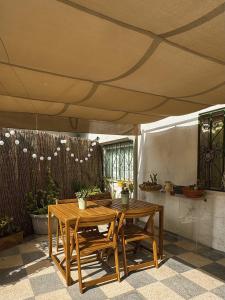 a wooden table and chairs under a tent at Cantinho da Avó Mifá in Lisbon +15 photos
